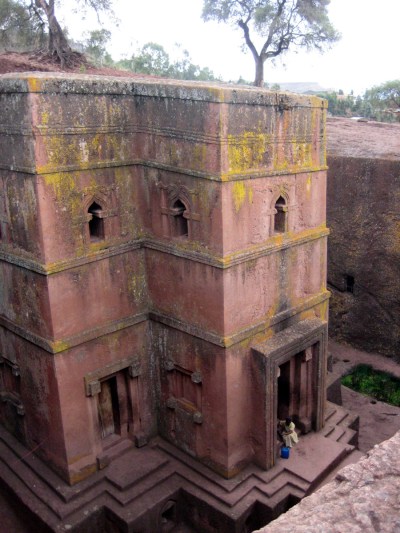 **  TO GO WITH ETIOPIA TURISTICA   ** FILE - This April 2010 file photo shows a nun sitting on the steps of The Church of St. George (or Bet Giorgis), one of the churches at Lalibela in Ethiopia.  Lalibela has a winding complex of 11 churches cut out of the rust-red granite tucked into a wind-swept moonscape. Legend claims it's the work of angels but in reality the complex was commissioned by the powerful 12th-century King Lalibela and picked out of the rock with hammers and chisels over decades.    (AP Photo/Jenny Barchfield, file)