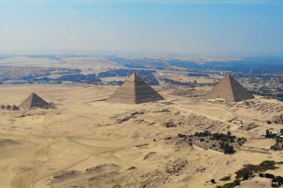 aerial view of Giza showing three pyramids