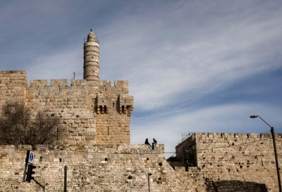 FILE - In this March 7, 2012 file photo, a couple sits next to the Tower of David on the wall surrounding Jerusalem's old city. Experts recently installed a seismic monitoring system in the Tower of David, part of Israelís initial steps to determine which ancient structures are in danger of earthquake-related collapse. (AP Photo/Sebastian Scheiner, File)