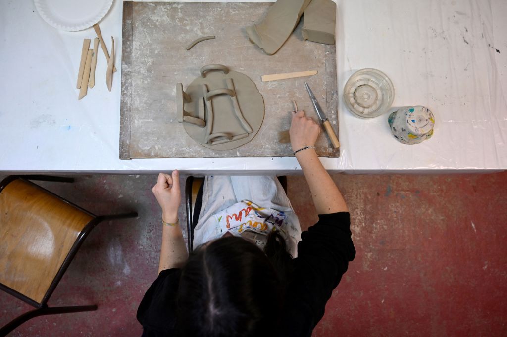 A university student, works with clay during an art therapy workshop proposed by the association "pool d'art" in Rennes, western France, on March 8, 2021. - Five art therapists offer free workshops to support university students in difficulty amidst the ongoing Covid-19 pandemic. (Photo by Damien MEYER / AFP) (Photo by DAMIEN MEYER/AFP via Getty Images)