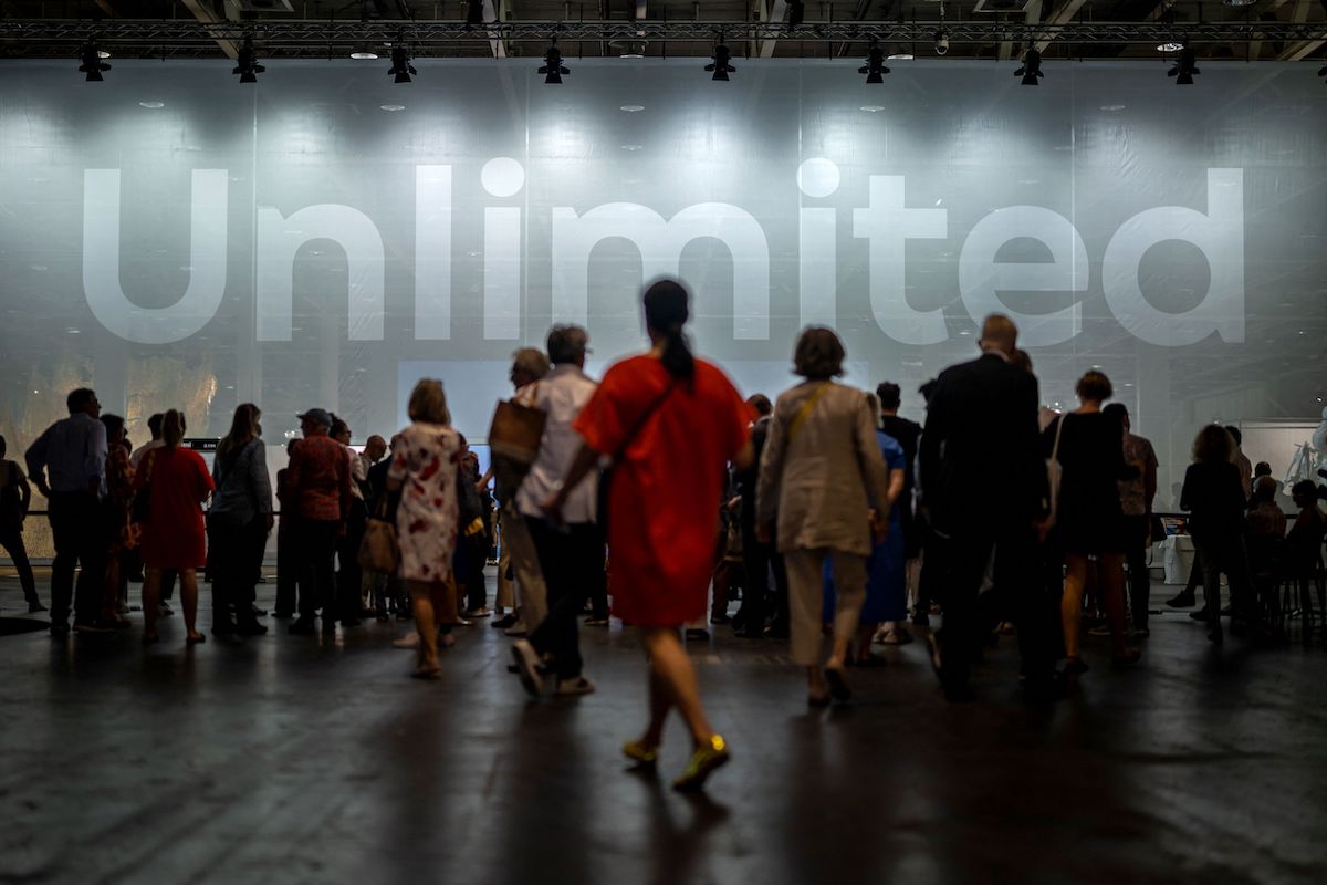 Visitors queue prior to the opening of the Unlimited sector of the Art Basel fair for Modern and Contemporary Art, in Basel, Switzerland on June 13, 2023. The fair will open to the public from June 15 to June 18, 2023 and features over 200 leading galleries and more than 4,000 artists from five continents. (Photo by FABRICE COFFRINI / AFP) (Photo by FABRICE COFFRINI/AFP via Getty Images)