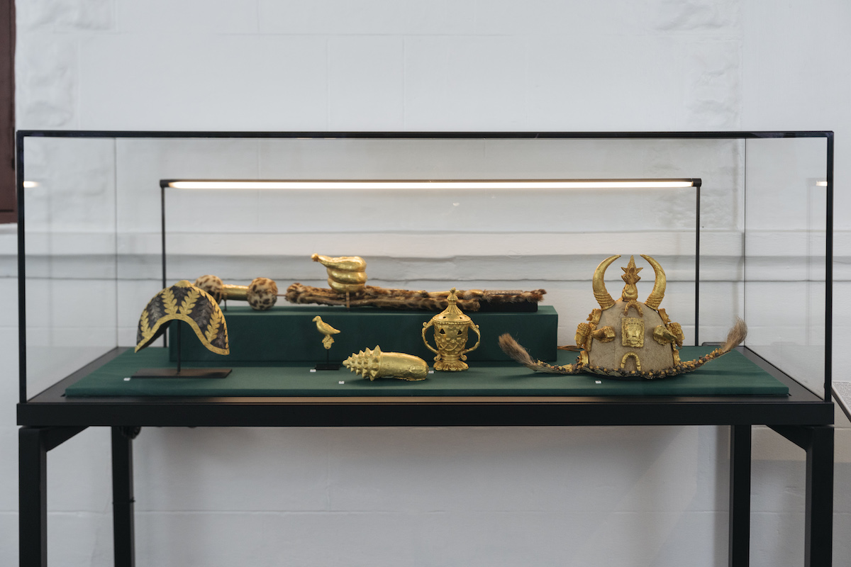 Golden artifacts in a glass display case.