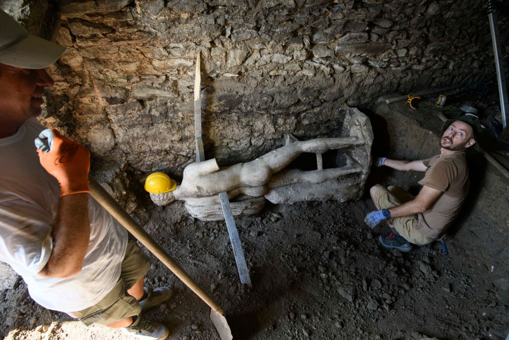 Archeologists work around an ancient statue discovered at the Heraclea Sintica archeological site, near the city of Petrich, Bulgaria, 2024.