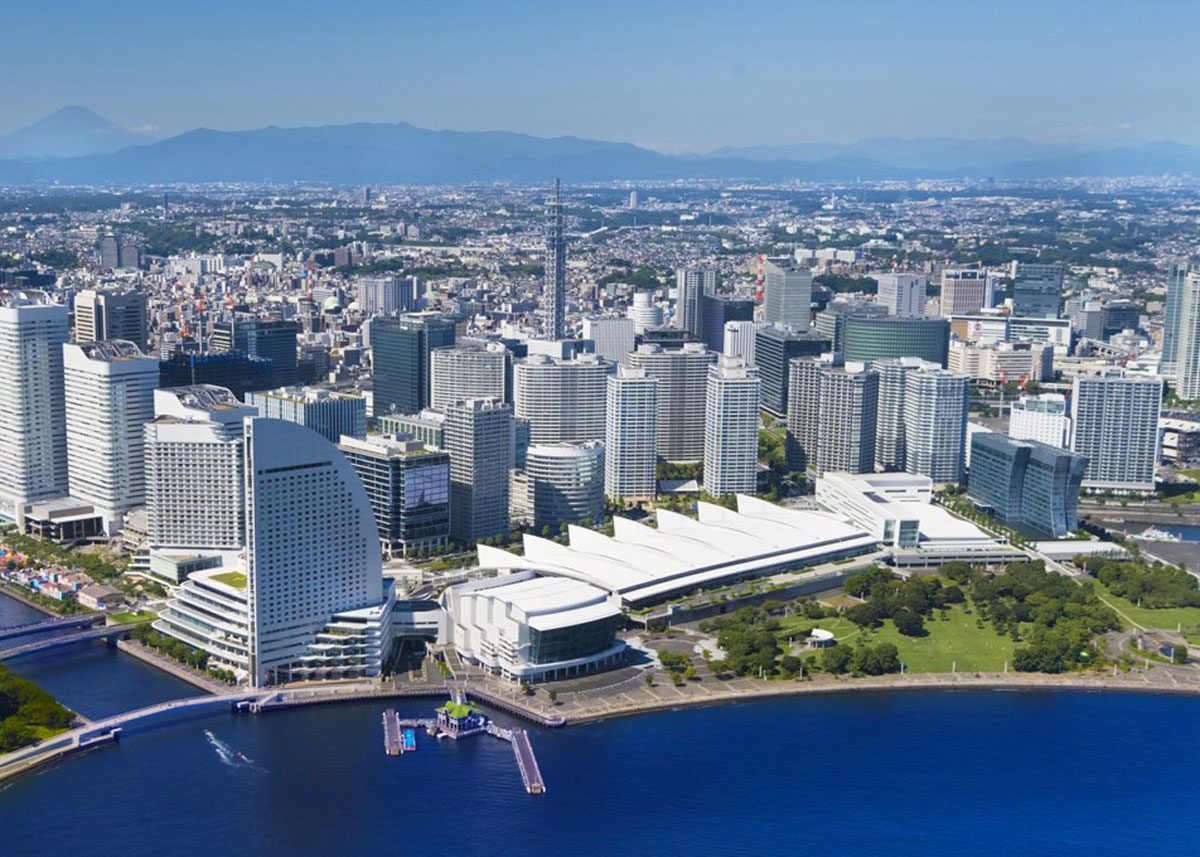 Skyline view of Yokohama showing a white convention center on the harbor.