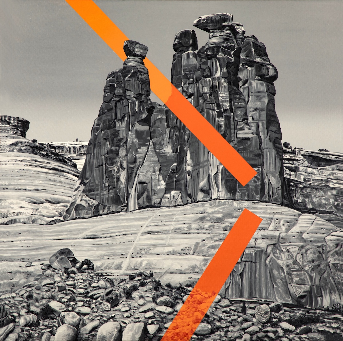 A black and white image of a rock formation with two diagonal orange stripes running thorugh it.